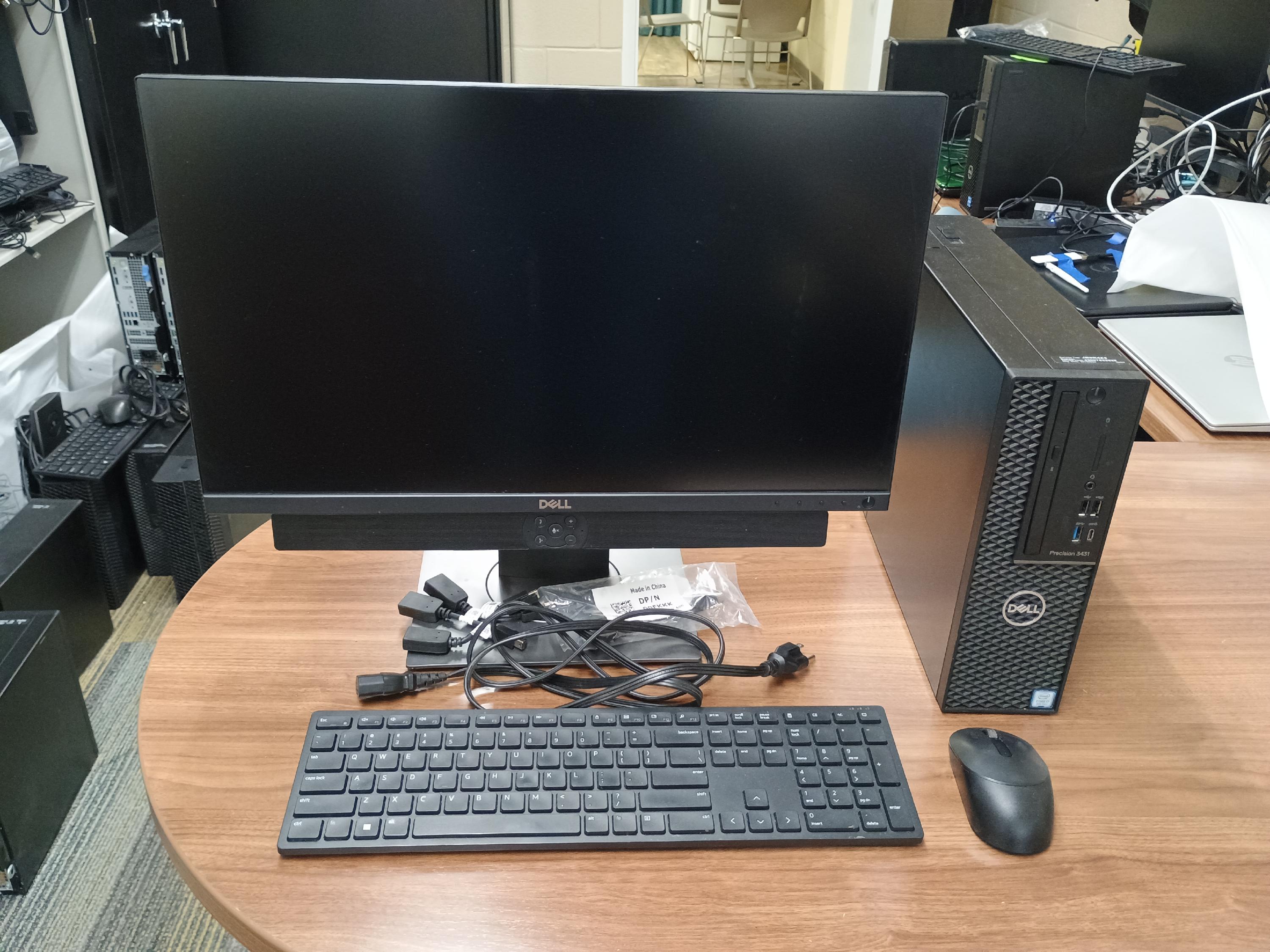 Desktop computer with mouse, keyboard, cables and adapters.